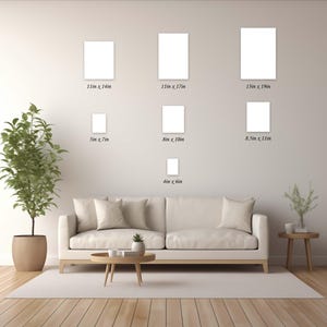May include: Seven blank white rectangular frames arranged on a wall above a sofa, with labels indicating sizes: 11in x 14in, 11in x 17in, 13in x 19in, 5in x 7in, 8in x 10in, 8.5in x 11in, and 4in x 6in, showcasing various print dimensions.