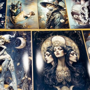 May include: A collection of rectangular art prints featuring fantasy illustrations, including a winged fairy, a cat in a hat, a mermaid, a seated elf on a mushroom, and a triple-faced goddess figure, all displayed in a grid-like arrangement.
