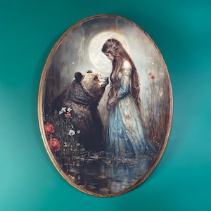 May include: Oval-shaped artwork depicting a woman in a blue dress and a bear in a forest setting. The woman has long brown hair and is looking at the bear. The bear is brown and appears to be looking at the woman. The background includes a full moon and flowers.