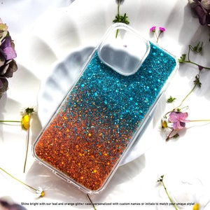 Op de afbeelding: Een transparante telefoonhoes met een teal en oranje glitterontwerp. De glitter is gelaagd, met de teal glitter bovenop en de oranje glitter onderaan.