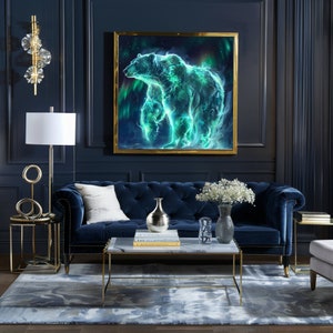 May include: A blue velvet sofa with white pillows in a living room setting. A framed print of a green and blue polar bear with a starry background hangs on the wall above the sofa. A gold metal coffee table with a marble top sits in front of the sofa.