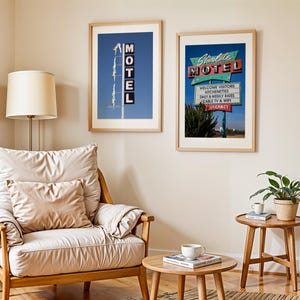 May include: Two framed prints of vintage motel signs hang on a beige wall. One sign reads "MOTEL" vertically against a blue sky. The other, "Starlite MOTEL," features a retro design with "Welcome Visitors" and "Vacancy" text.