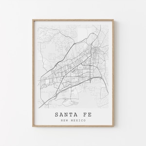 May include: A framed black and white map print of Santa Fe, New Mexico. The map details the city's road network and geographical features. The text "SANTA FE NEW MEXICO" is printed at the bottom of the map.