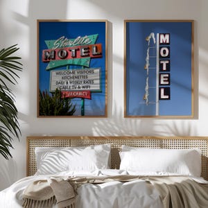 May include: Two framed prints with a retro motel theme. One features a sign that reads "Starlite MOTEL" with "Welcome Visitors" and other text. The other shows a "MOTEL" sign with figures diving. Both have a blue sky background.