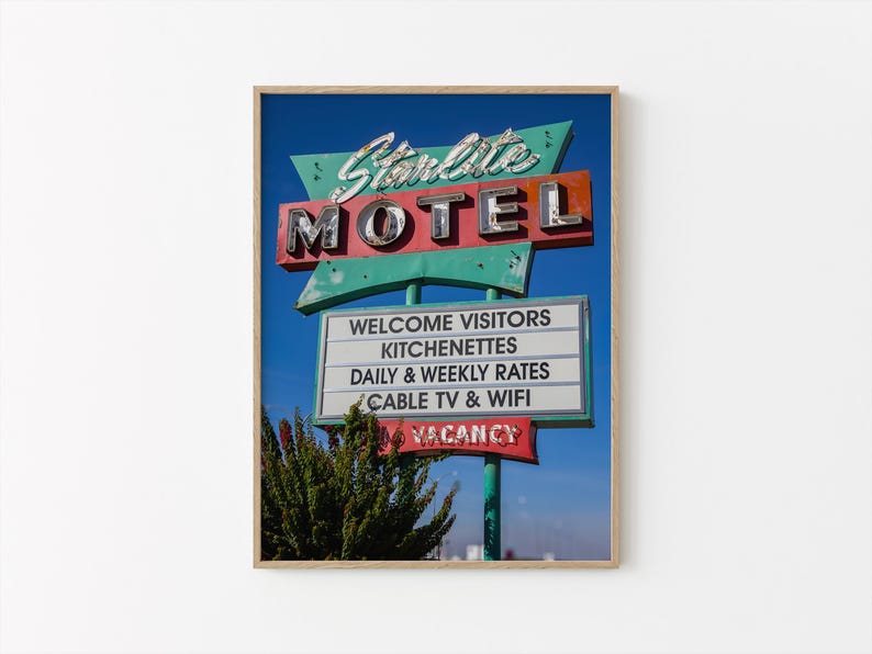 May include: A framed print of the Starlite Motel sign against a blue sky. The sign features the word "MOTEL" in large, chrome letters, with "Starlite" in cursive above. Additional text includes "Welcome Visitors," "Kitchenettes," and "Vacancy."