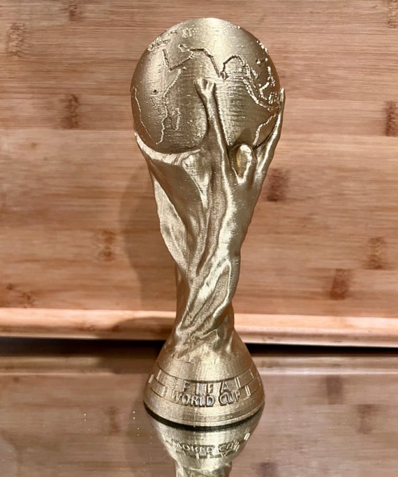 A miniature replica of the World Cup trophy presented by FIFA to