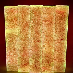 May include: Five rectangular blocks arranged side by side, each featuring a marbled pattern of vibrant orange and glowing yellow hues. The surfaces exhibit a textured, swirling appearance with high-contrast color blending throughout each piece.