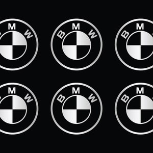 Puede incluir: Seis logotipos BMW de color plateado sobre un fondo negro. Cada logotipo presenta las letras "BMW" con la "M" en el centro y un patr&oacute;n de cuadros blancos y negros.