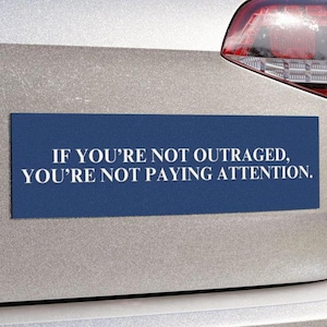 May include: Blue bumper sticker with white text that reads "If you're not outraged, you're not paying attention."