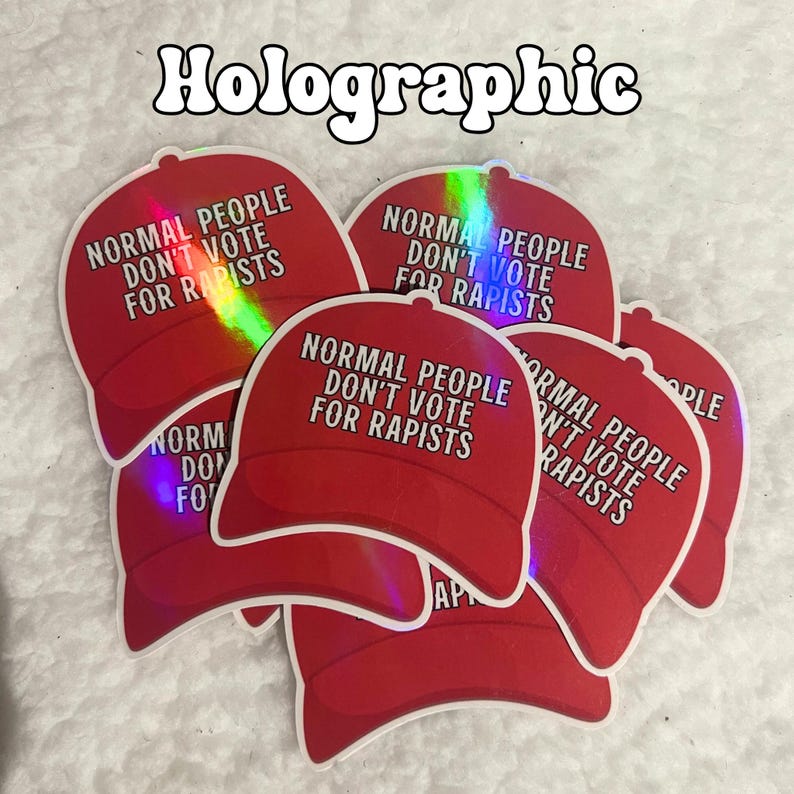 May include: A stack of five red and white holographic stickers with the text "Normal People Don't Vote For Rapists" on each sticker. The stickers are shaped like a baseball cap.
