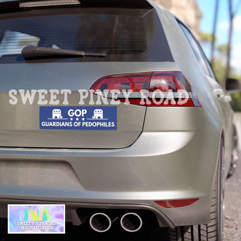 May include: A silver car with a bumper sticker that reads "GOP GUARDIANS OF PEDOPHILES". The car also has the text "SWEET PINEY ROAD" across the top. A smaller sticker at the bottom reads "SWEET PINEY ROAD ORIGINAL DESIGN".