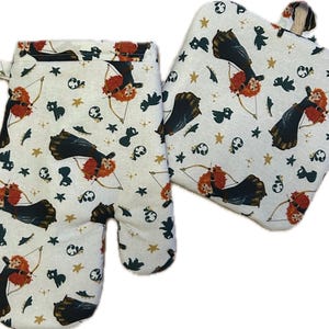 May include: A set of two kitchen oven mitts with a white background and a repeating pattern of a cartoon character with red hair holding a bow and arrow. The character is wearing a green dress and is surrounded by stars and other small details.