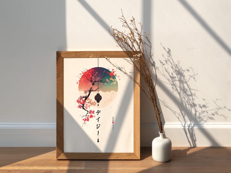 May include: A framed art print featuring a Japanese-inspired design. The artwork depicts a tree with pink blossoms, a hanging lantern, and a colorful sunset. The print is in a wooden frame and is displayed on a wooden surface.