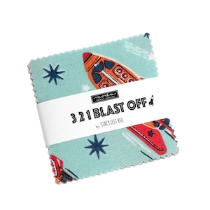May include: A stack of fabric squares with a space theme. The squares are light blue with a repeating pattern of rockets and stars. The text "3 2 1 BLAST OFF" is printed on a white band wrapped around the fabric squares.