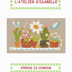 May include: A decorative illustration featuring a row of potted plants, including cacti and flowers, on a shelf. The image includes the text "L'ATELIER D'ISABELLE" and "SPRING IS COMING" in red and green. The artwork has a neutral background.