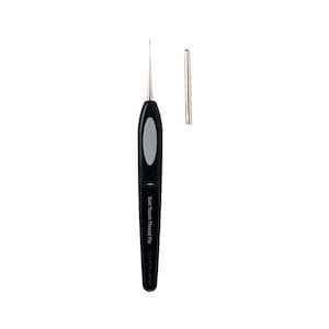 May include: A black Soft Touch Thread Pic tool with a silver needle and a separate silver cap. The handle has a gray oval grip. The tool is designed for crafting and sewing projects.