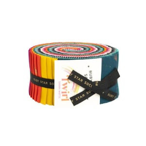 May include: A roll of colourful fabric with a label that says "Twirl" by Sarah Watts, Ruby Star Society. The fabric is in a variety of colours, including teal, yellow, orange, red, and pink.