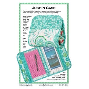 May include: Two folding organizers with a teal and white floral pattern. One is folded shut, while the other is open, revealing a pink mesh pocket containing a black pen and a slot holding a Tongass National Forest map. Text reads JUST IN CASE.