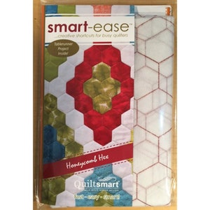 May include: A quilting pattern package with a honeycomb design. The package includes a white fabric with red stitching and a colorful fabric sample with a honeycomb pattern. The package is labeled "smart-ease" and "Honeycomb Hex".