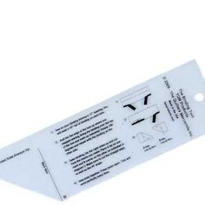 May include: A clear acrylic quilting ruler labeled The Binding Tool by TQM Products. The tool features printed instructions, diagrams, and markings including A and B corners, a 45-degree angle guide, and the text Printed Side Always Up for sewing.