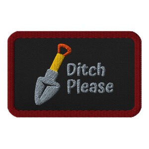 May include: Embroidered patch with a black background and a red border. The patch features a small shovel with a yellow handle and a gray blade, along with the words "Ditch Please" in white text.