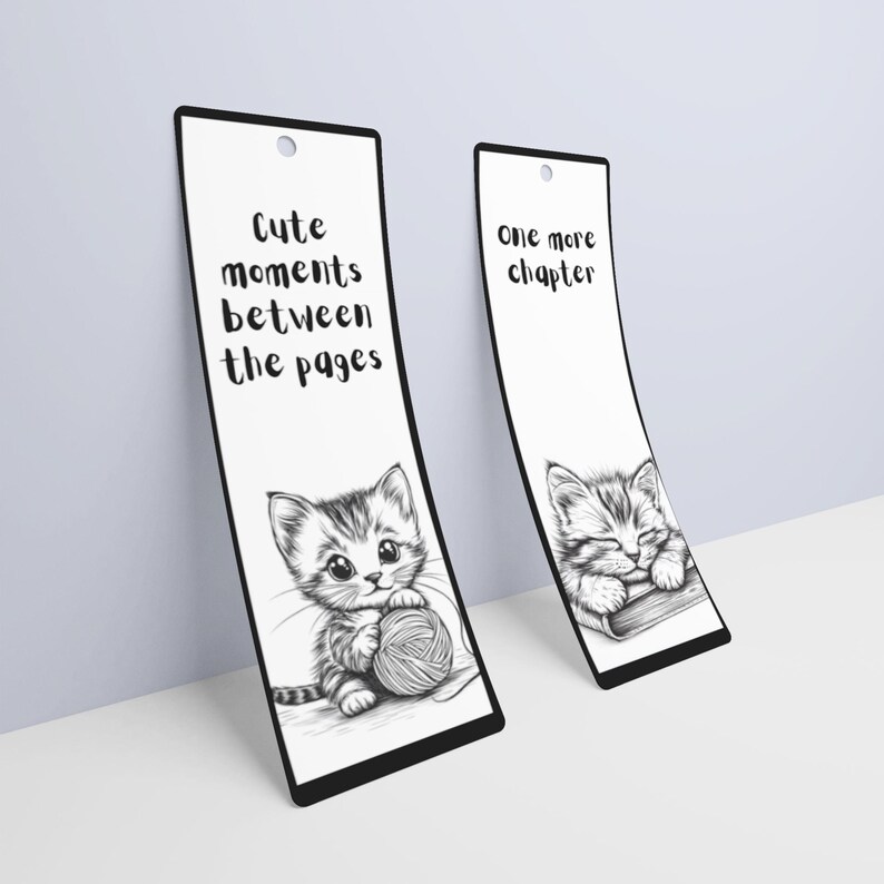 May include: Two black and white bookmark designs featuring a cute kitten. One bookmark says "Cute moments between the pages" and the other says "One more chapter".