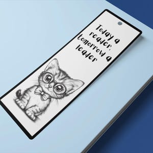May include: A white bookmark with a black and white illustration of a cat wearing glasses and a bow tie. The text "Today a reader, tomorrow a leader" is printed on the bookmark.