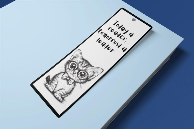 May include: A white bookmark with a black and white illustration of a cat wearing glasses and a bow tie. The text "Today a reader, tomorrow a leader" is printed on the bookmark.