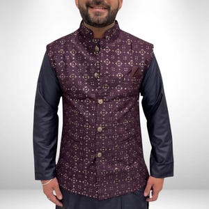May include: A formal ensemble featuring a patterned vest in deep purple with gold accents, paired with a navy blue long-sleeved shirt and matching pants. The vest has a high collar and decorative buttons, suitable for special occasions.