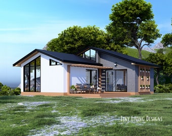 Op de afbeelding: Een moderne, witte en grijze buitenkant van een klein huis met een zwart dak en grote ramen. Het huis heeft een houten terras en een kleine tuin met groen gras.