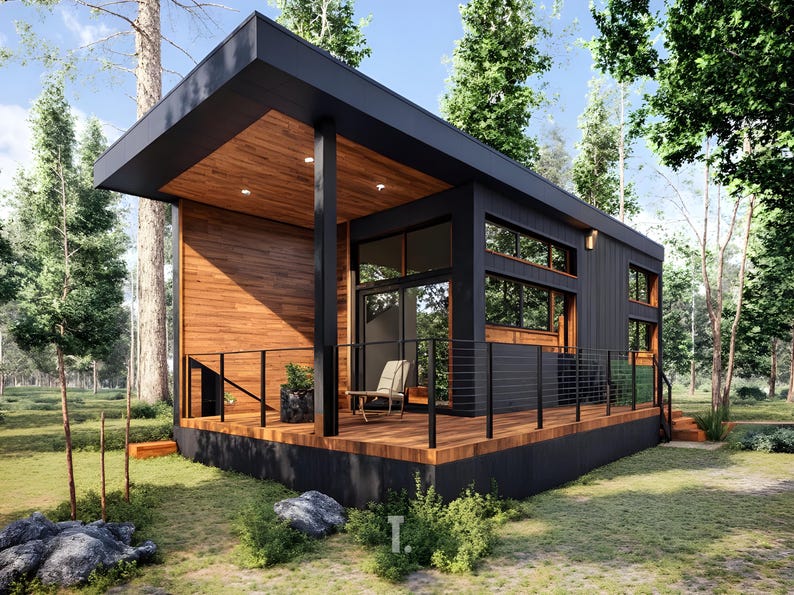 May include: Modern black cabin with a wooden deck and accents. The cabin features large windows, a flat roof, and a small porch with a chair. The exterior is surrounded by trees and greenery, creating a natural setting. The cabin is a contemporary architectural design.