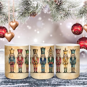 May include: White ceramic mug featuring a watercolour illustration of several toy nutcracker soldiers in various colours. The background is a light beige with a festive Christmas theme, including ornaments and pine branches.