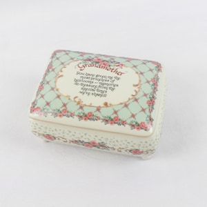 May include: A white ceramic keepsake box with a green and white checkered pattern and pink roses. The lid has the text "Grandmother You have given me the most priceless of heirlooms - memories to treasure from the special times we've shared!"