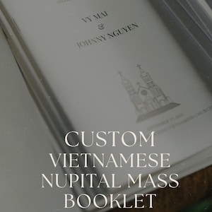 May include: A custom Vietnamese nuptial mass booklet. The cover features the names Vy Mai and Johnny Nguyen, with the text "The Nuptial Mass Celebrating the Union Of". The booklet has a church illustration and the words "Custom Vietnamese Nupital Mass Booklet".