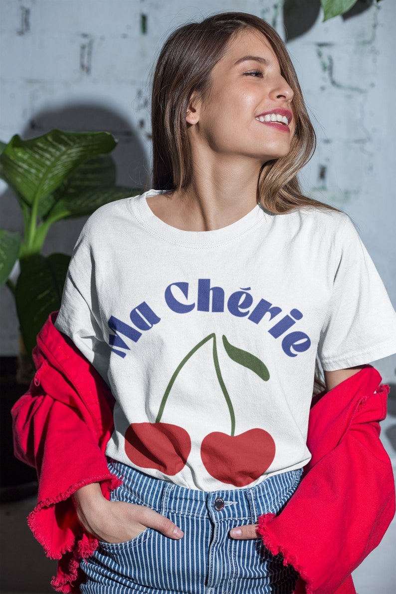 May include: White t-shirt with a blue and green graphic of two cherries and the text "Ma Ch&eacute;rie".