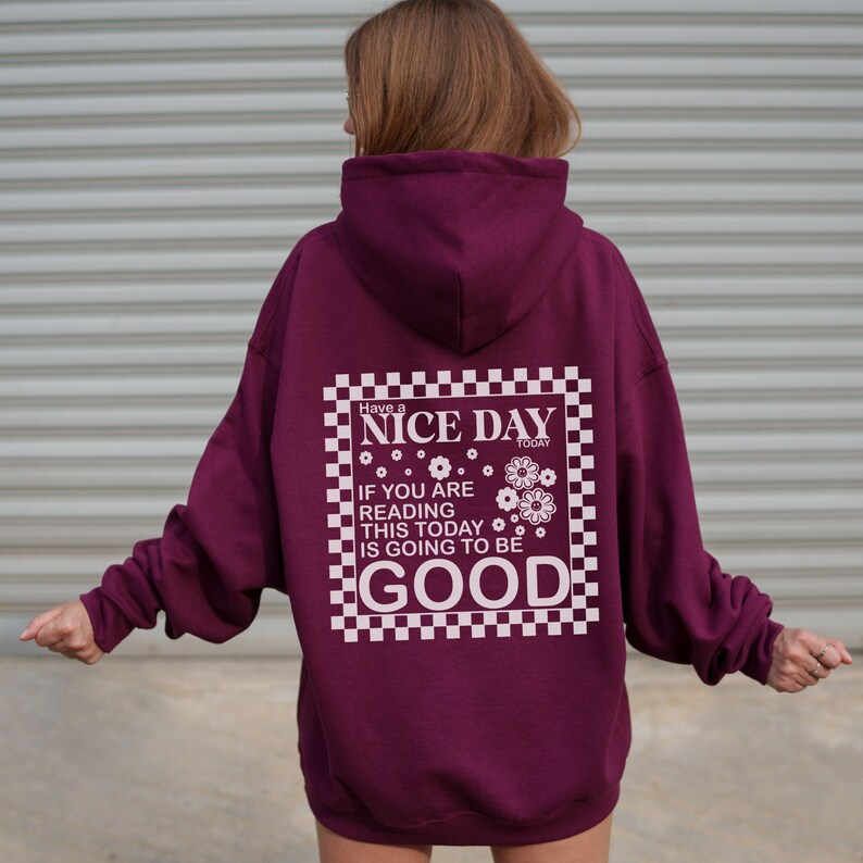 May include: Burgundy hooded sweatshirt with a white checkered graphic that says "Have a Nice Day Today" and "If you are reading this today is going to be good".