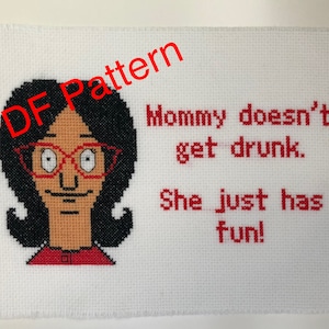 May include: Cross-stitch pattern featuring a cartoon image of a woman with black hair, red glasses, and a red shirt. The text "Mommy doesn't get drunk. She just has fun!" is stitched in red.