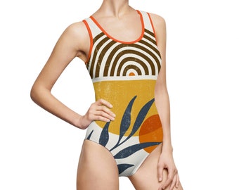 May include: A white swimsuit with a geometric pattern in shades of brown, orange, and yellow. The pattern features a stylized sun, leaves, and stripes.