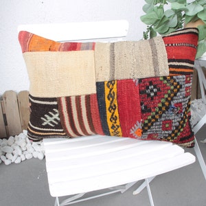 May include: A colorful patchwork pillow with a variety of textures and patterns, including stripes, geometric designs, and floral motifs. The pillow is made from recycled materials and is perfect for adding a touch of bohemian style to any room.