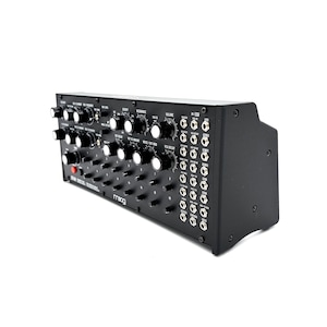May include: A black synthesizer with numerous knobs, switches, and input/output jacks. The front panel features white text and the brand name "moog". The device has a rectangular shape with a slightly angled right side.