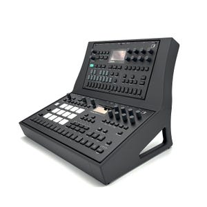 May include: A black electronic music production device featuring an array of buttons, knobs, and a small screen. The device has a slanted design and a built-in stand. The text "Maschine Studio MK3" is visible.