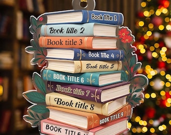 May include: A decorative ornament shaped like a stack of books, each labeled with a different "Book title" from 1 to 10. The books are in various colors, with a floral and leaf design around the edges. A gold loop is at the top for hanging.