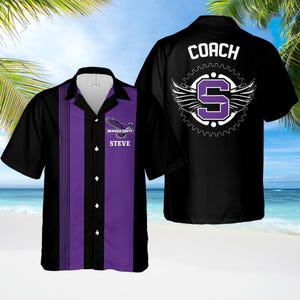 May include: Black and purple short-sleeved shirt. The shirt has a purple vertical stripe down the front and the text "DENVER SOUTH" and "STEVE". The back of the shirt features the word "COACH" and a winged "S" logo.