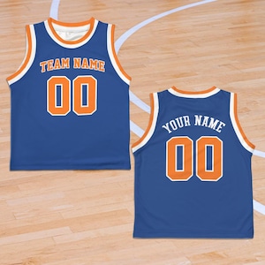 May include: Blue basketball jersey with orange and white accents. The front displays "TEAM NAME" above the number "00". The back shows "YOUR NAME" above the number "00". The jersey has a round neck and sleeveless design.