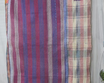 May include: A vintage woven tapestry with a striped pattern in shades of purple, blue, and white. The tapestry has a plaid section on the right side with a small patch of solid purple fabric.