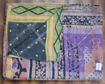 May include: A multi-colored kantha quilt with a purple, yellow, green, and black patchwork design. The quilt is folded in half and has a tag that says "20-10".