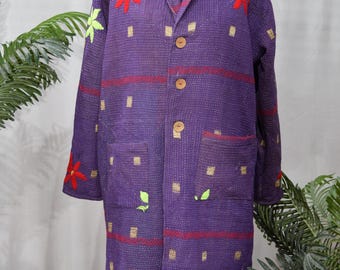 May include: A long purple quilted jacket with a shawl collar and button closure. The jacket has a geometric pattern and is decorated with embroidered flowers and leaves in red, green, and gold.