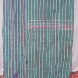 May include: A handmade quilt with a teal and purple striped pattern. The quilt features vertical stripes with a pink and white plaid section. The stitching is visible, and the quilt is made of a soft fabric.