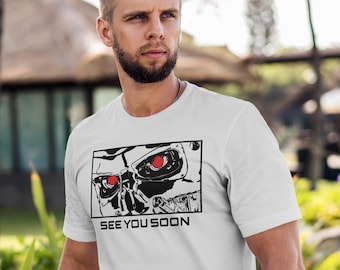 May include: White t-shirt featuring a black and white illustration of a robot face with red eyes. The text "SEE YOU SOON" is printed below the illustration.