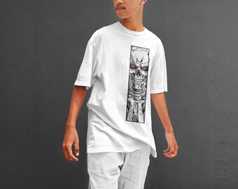 May include: White t-shirt with a vertical graphic of a robotic skull with red eyes. The design is in black and grey, set against a white background. The shirt is part of a casual clothing collection.